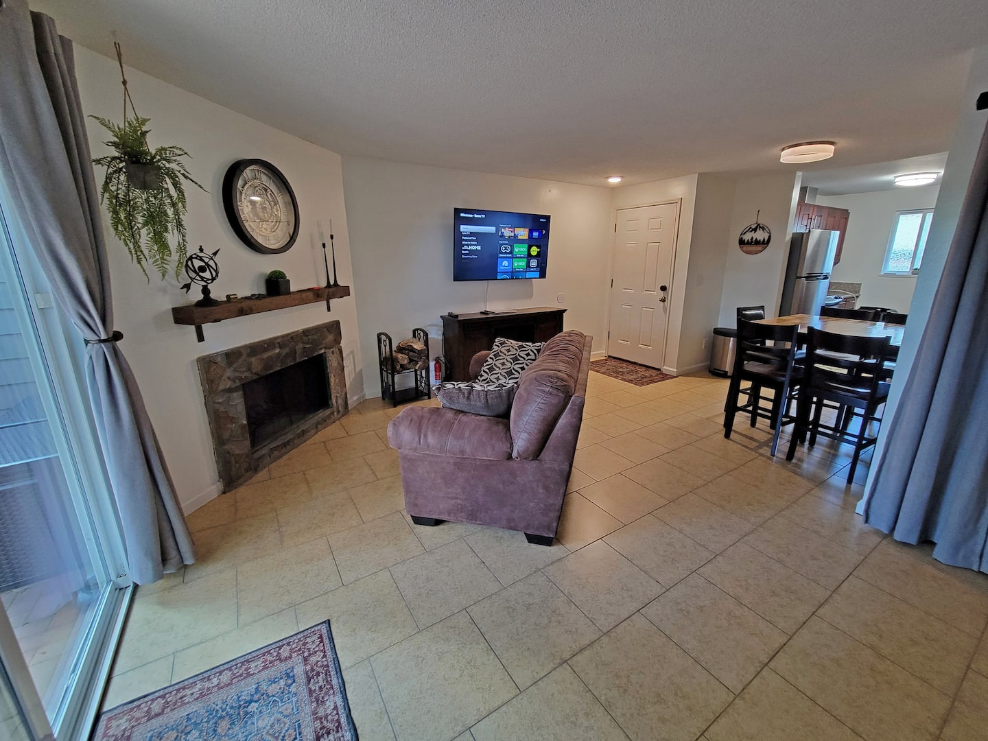 Cozy up in the living room, where the warm embrace of a fireplace awaits. Enjoy the ambience of a decorative mantel, with peace of mind provided by a readily available fire extinguisher – the perfect blend of comfort and safety.
